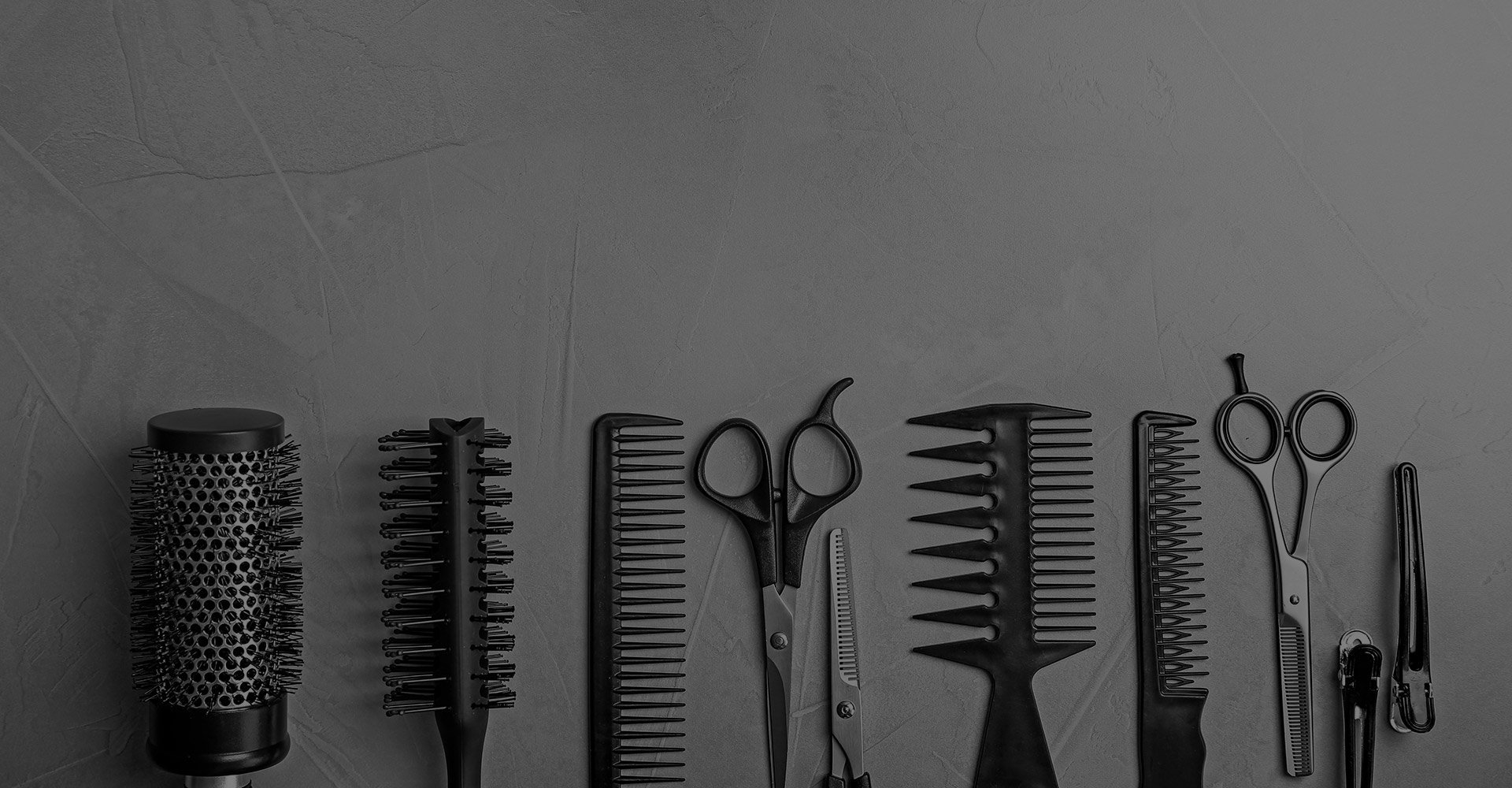 image of clean hair cutting tools laying on a table in a line
